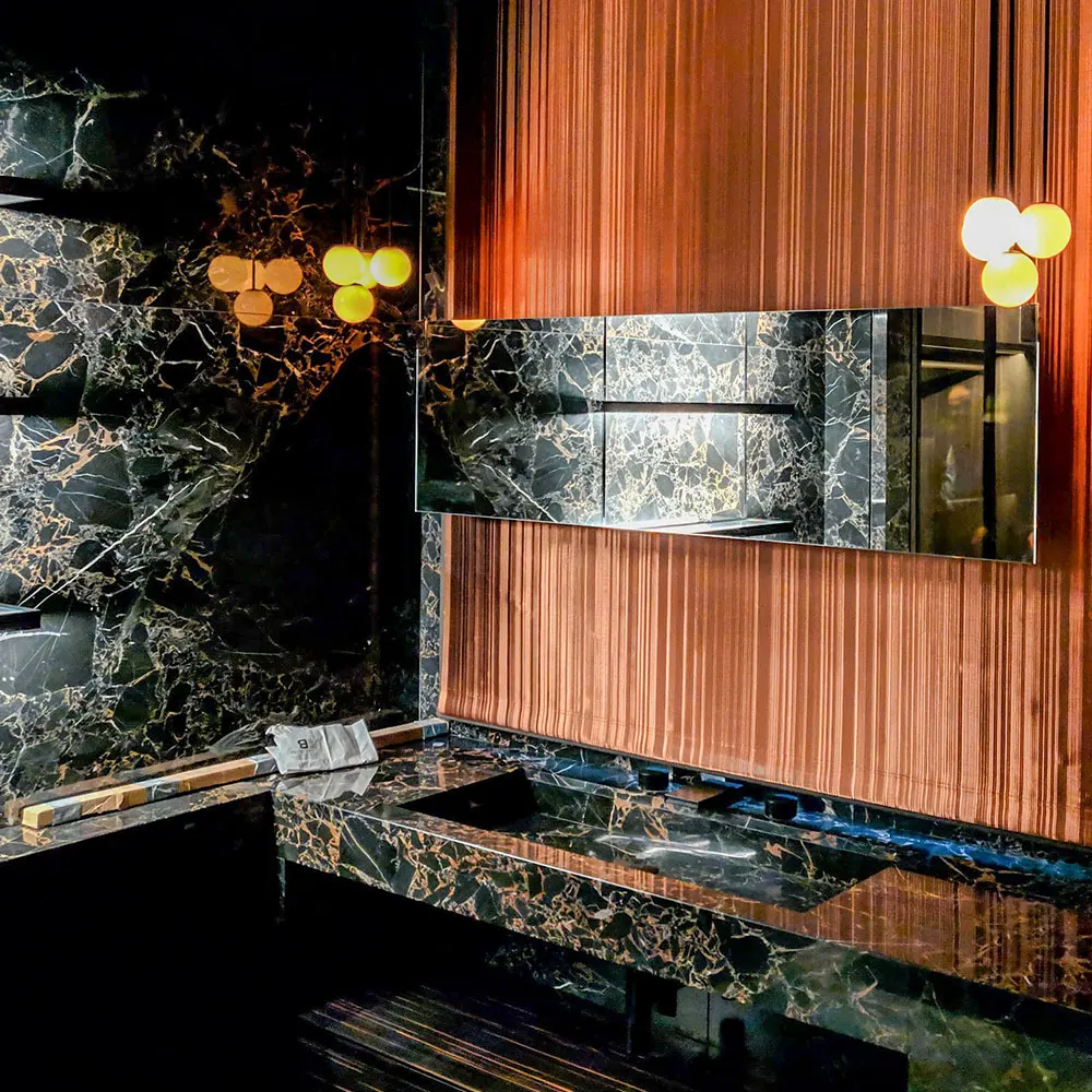 Bathroom with dramatic accent lighting on stone and timber