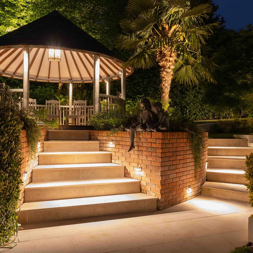 Garden steps and a gazebo lit at night