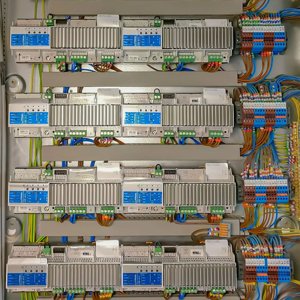 Neatly wired Lutron lighting control panels in a plant room