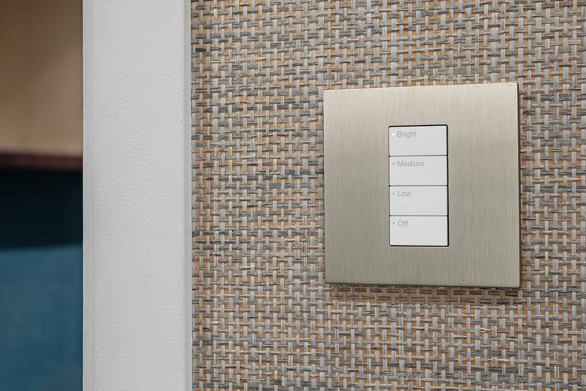Lutron Vierti keypad in satin nickel with engraved Bright, Medium, Low and Off buttons on a grasscloth wall