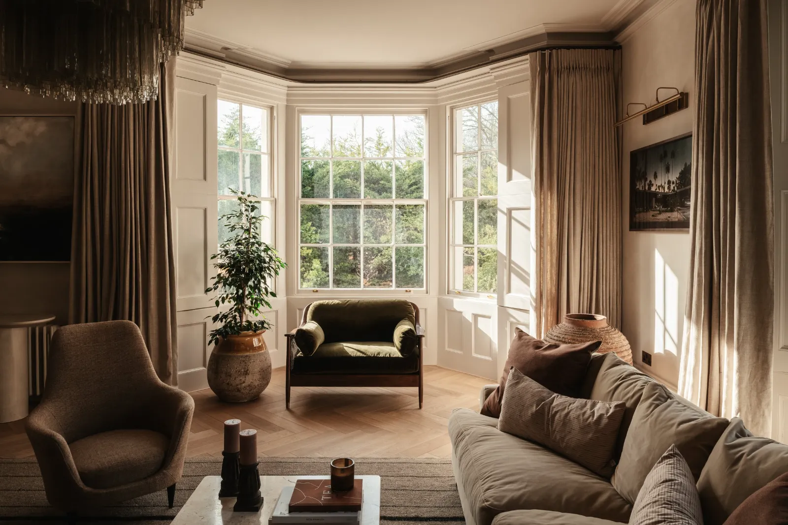 Bay-windowed sitting room with table lamps and wall lights