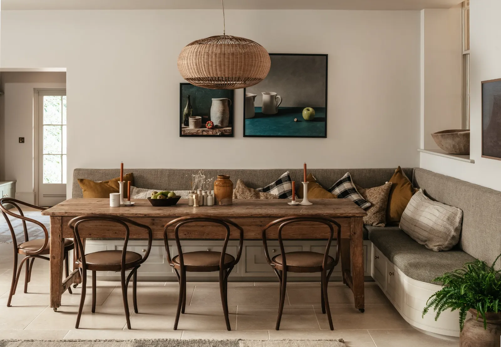 Dining table under a woven pendant light