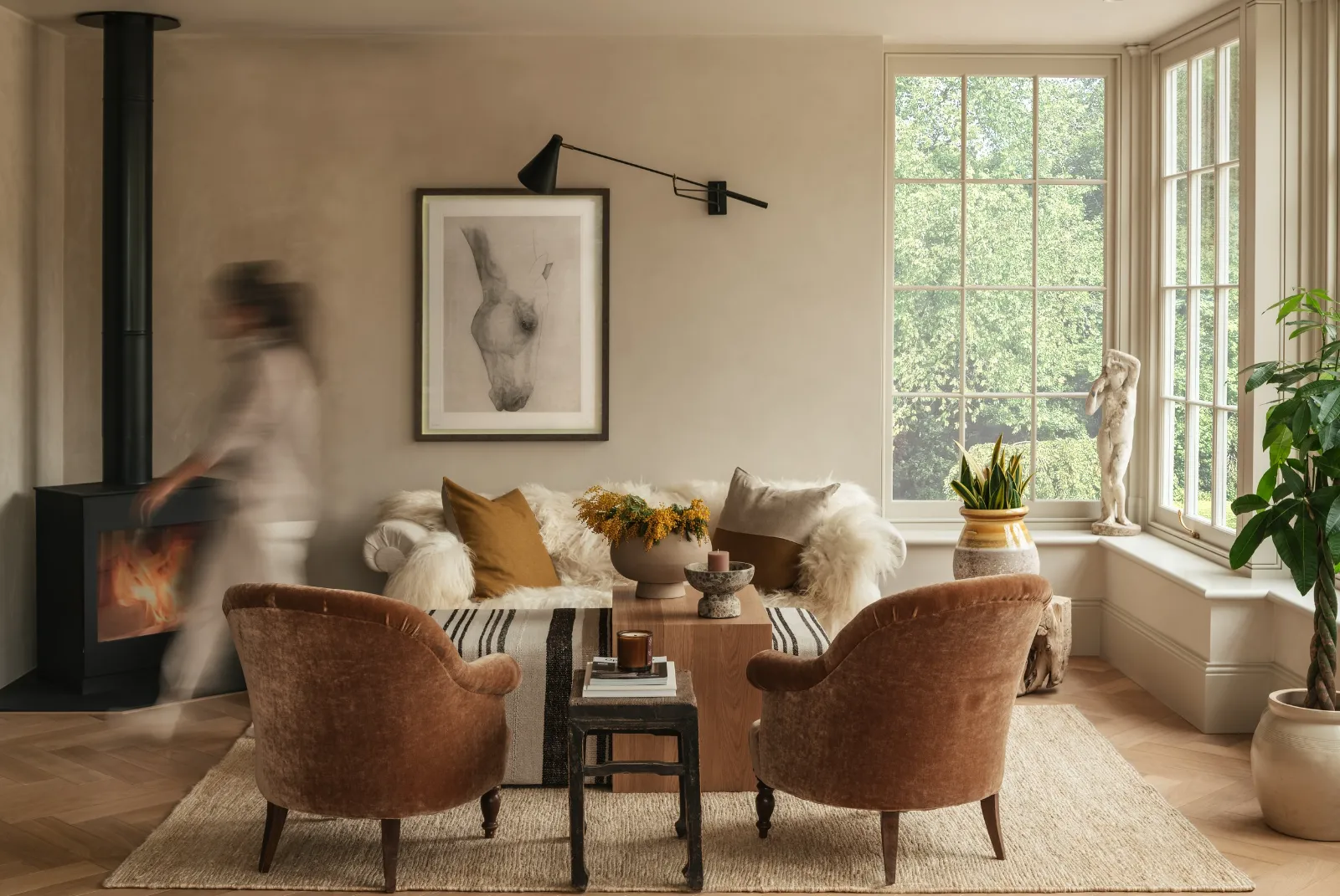 Bright sitting room with armchairs by a large window