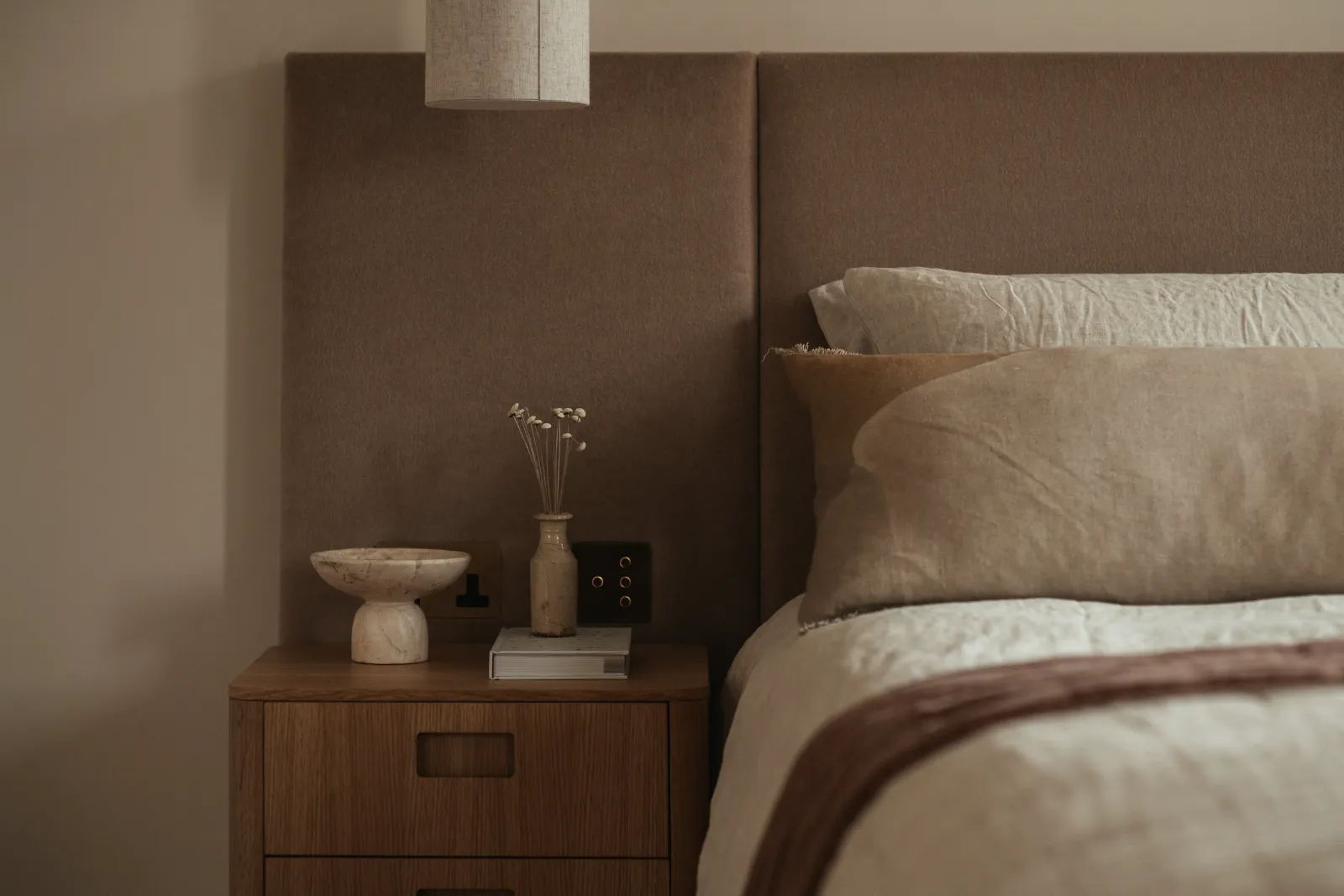 Bedroom with a low headboard and soft bedside light